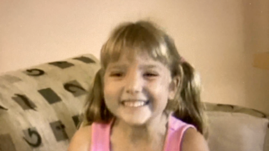 Dear younger self blog feature image Photo of Rachael from her childhood, smiling on a couch